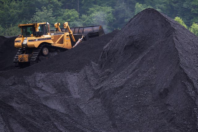 A bulldozer operates atop a coal mound at the CCI Energy Slones Branch Terminal June 3, 2014 in Shelbiana, Kentucky.