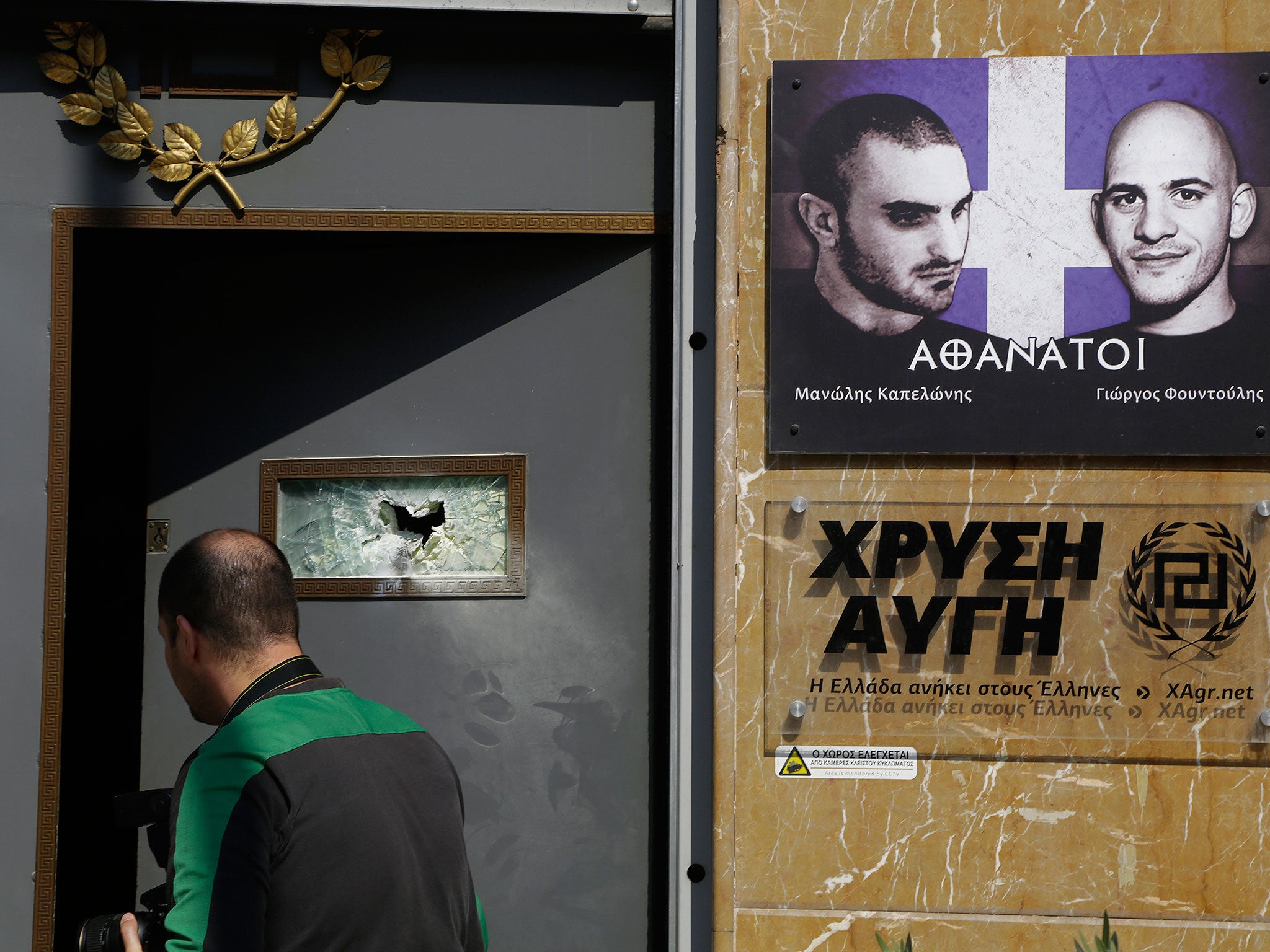 An investigator seen outside of the main offices of Greece's extreme right Golden Dawn party after an attack on 31 March