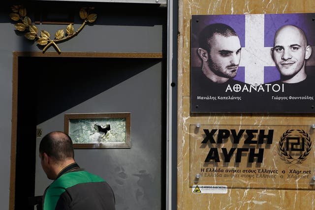 An investigator seen outside of the main offices of Greece's extreme right Golden Dawn party after an attack on 31 March