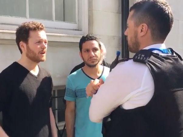 Anti war activist Sam Walton talks to police after attempting to perform a citizen's arrest on a Saudi general