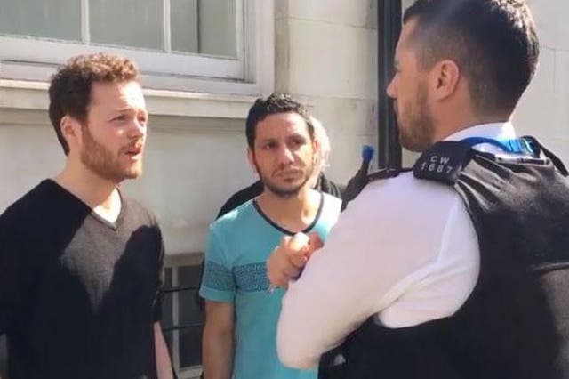 Anti war activist Sam Walton talks to police after attempting to perform a citizen's arrest on a Saudi general