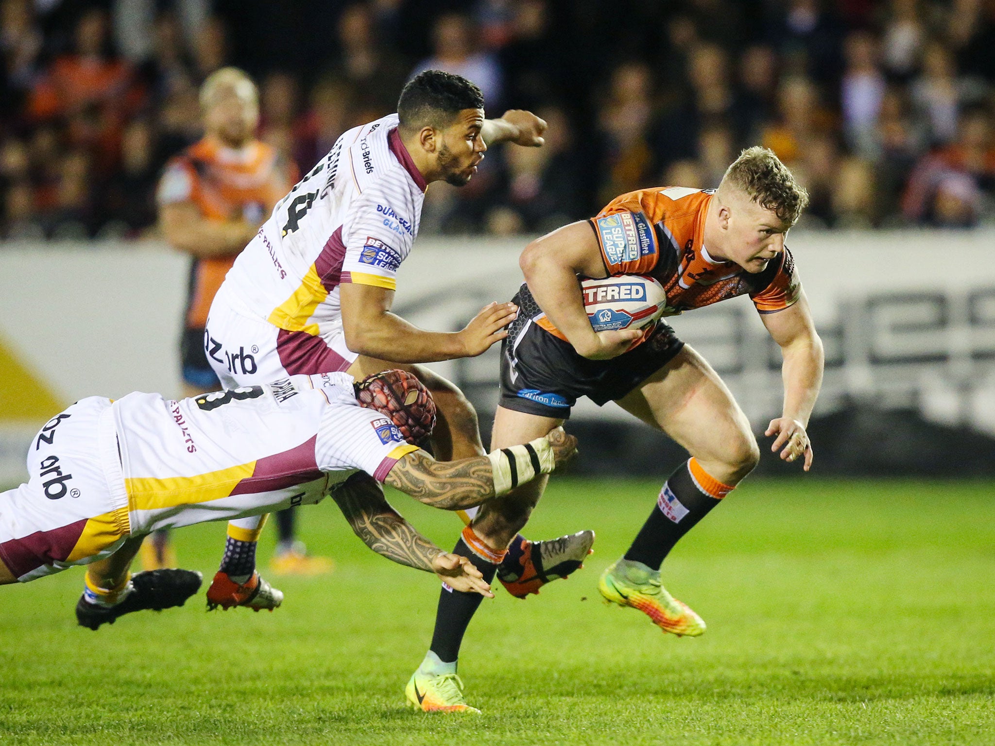 Adam Milner breaks through the Huddersfield line to score a try for Castleford