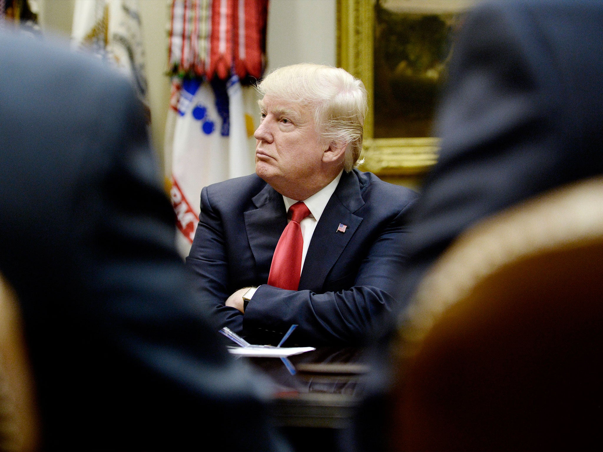 Donald Trump looks on during a meeting in the Roosevelt Room of the White House