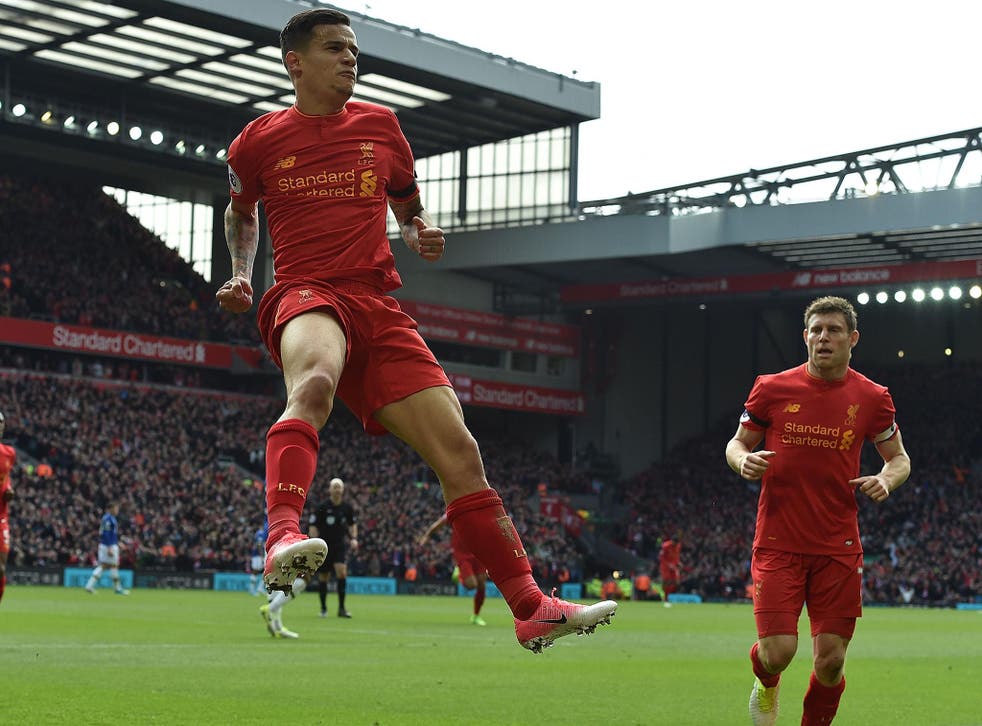 Philippe Coutinho leaps in celebration after scoring Liverpool's second goal against Everton