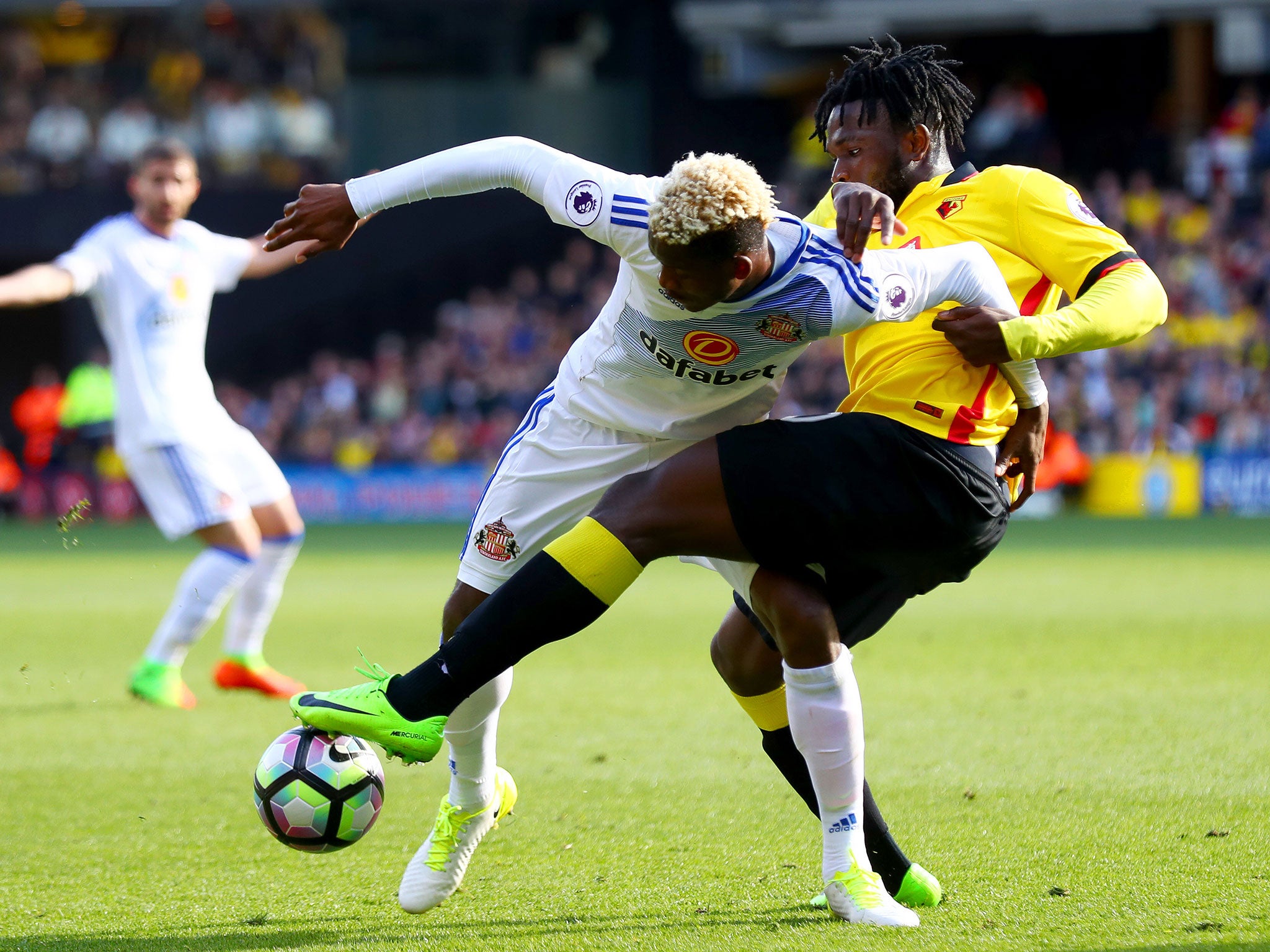 Dider N'dong and Isaac Success tussle for possession