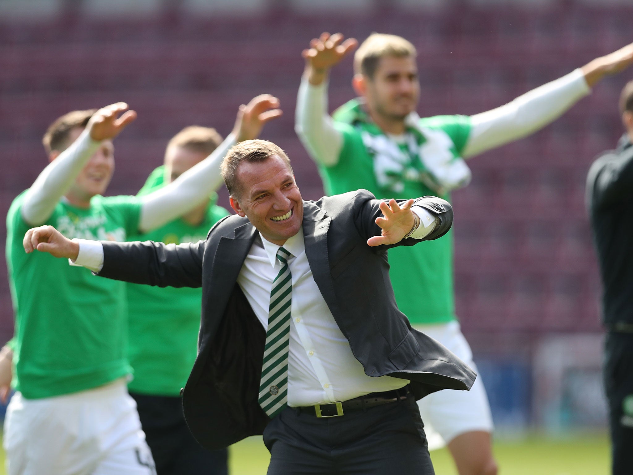 Brendan Rodgers celebrates with his players after the final whistle