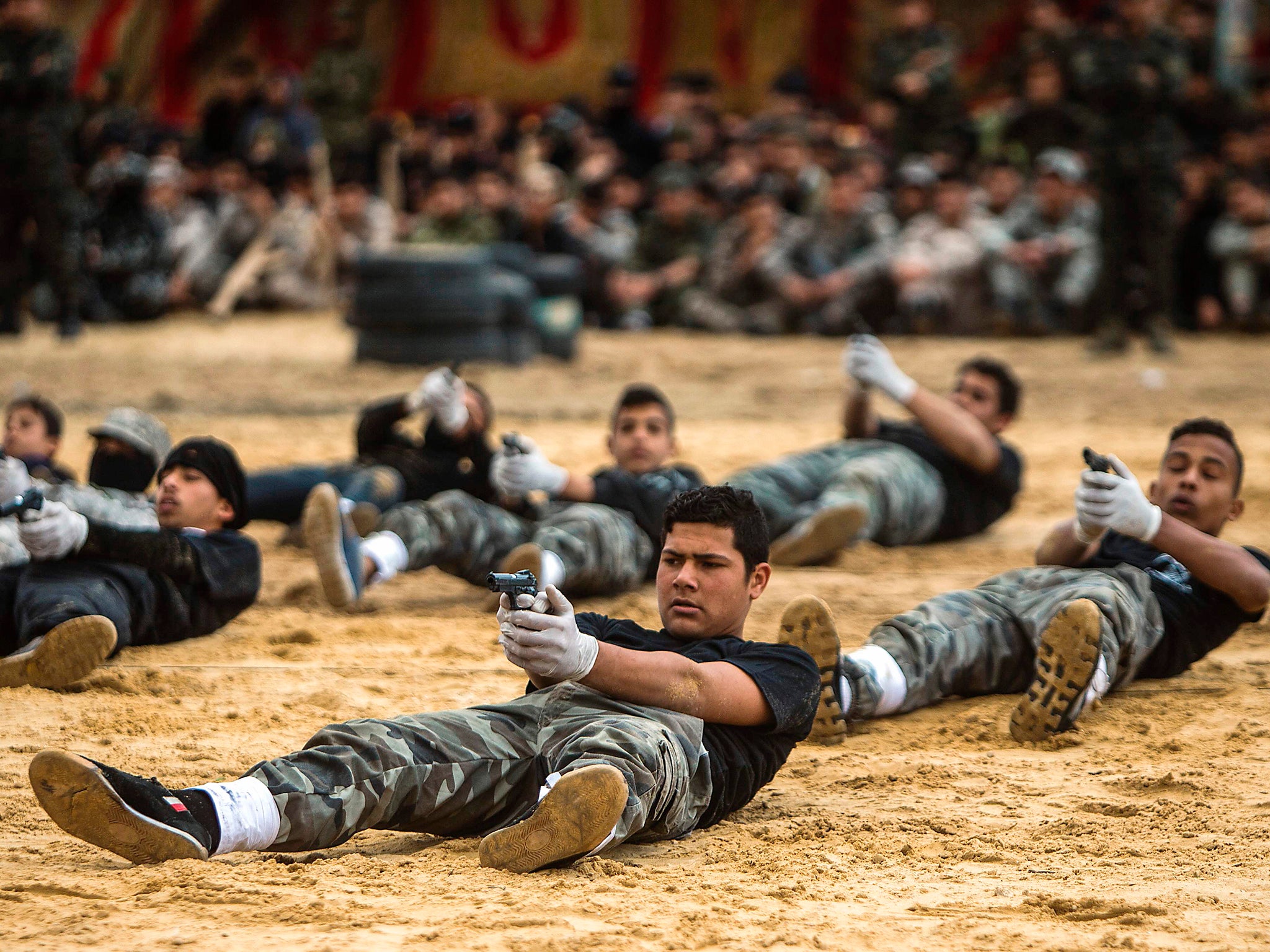 &#13;
Palestinian high school students show off their skills during a graduation ceremony from a military school course organised by the Hamas security forces and the Hamas Ministries of Interior and Education (Getty)&#13;