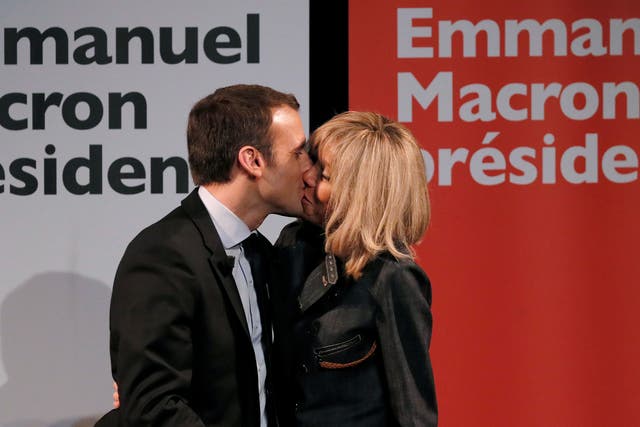 Emmanuel Macron kisses his wife Brigitte Trogneux