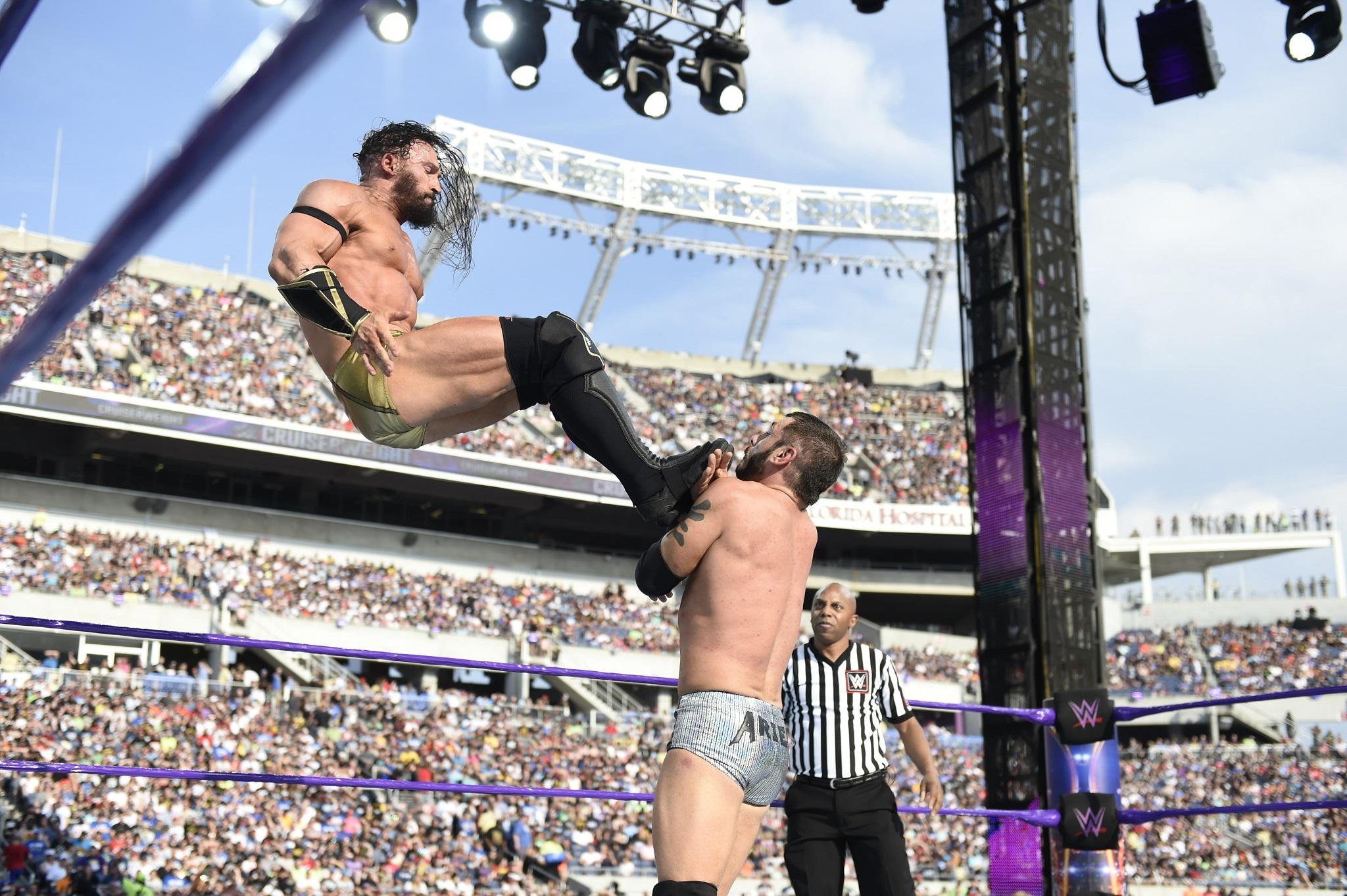 Pac/Neville delivers a dropkick to Austin Aries at WrestleMania 33