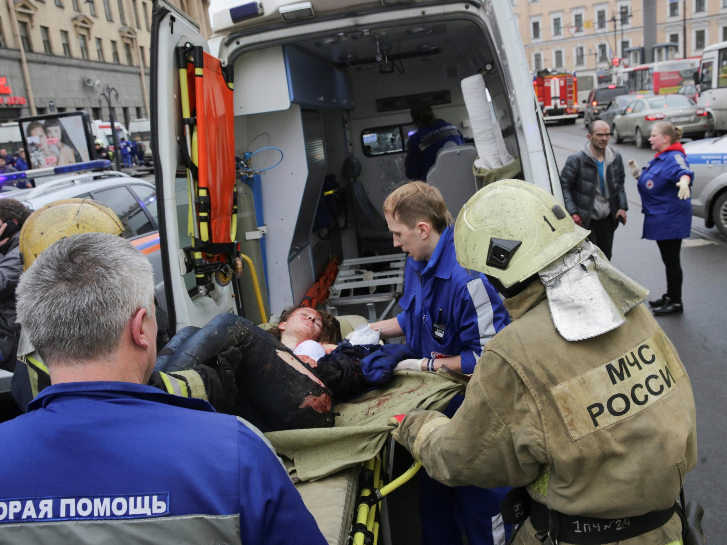 An injured person is helped by emergency services outside Sennaya Ploshchad metro station