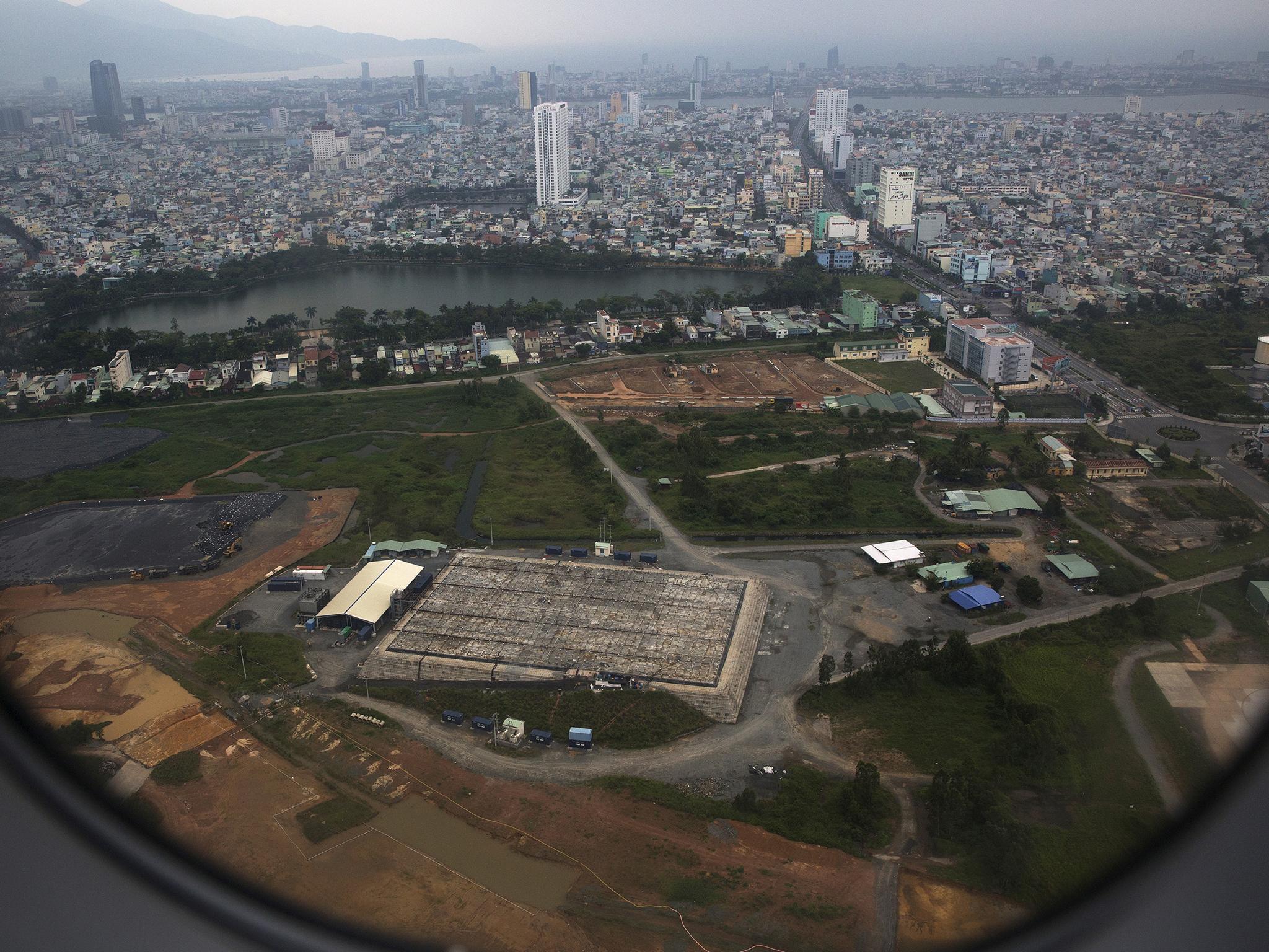 The cleaning operation of the area that was used for storing Agent Orange is seen from a plane taking off from Danang international airport