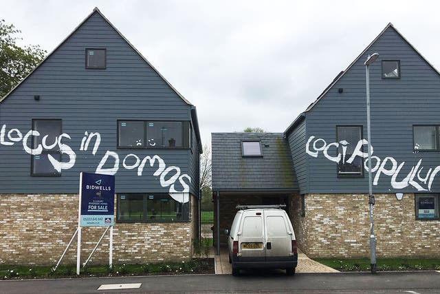 Newly built luxury homes in Cambridge which have been vandalised with graffiti - in Latin