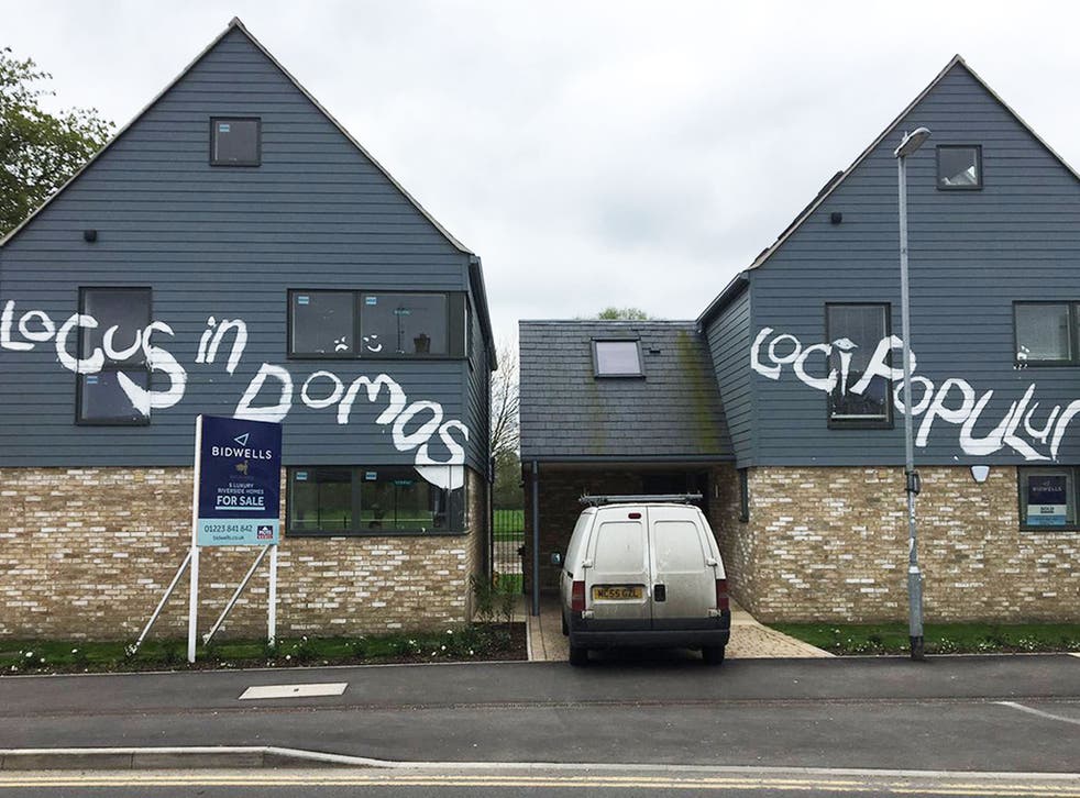Newly built luxury homes in Cambridge which have been vandalised with graffiti - in Latin