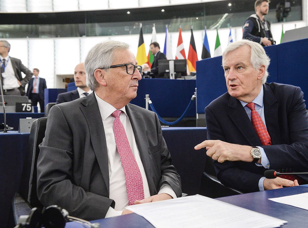 Michel Barnier (R) speaks with European Commission President Jean Claude Juncker at the European Parliament