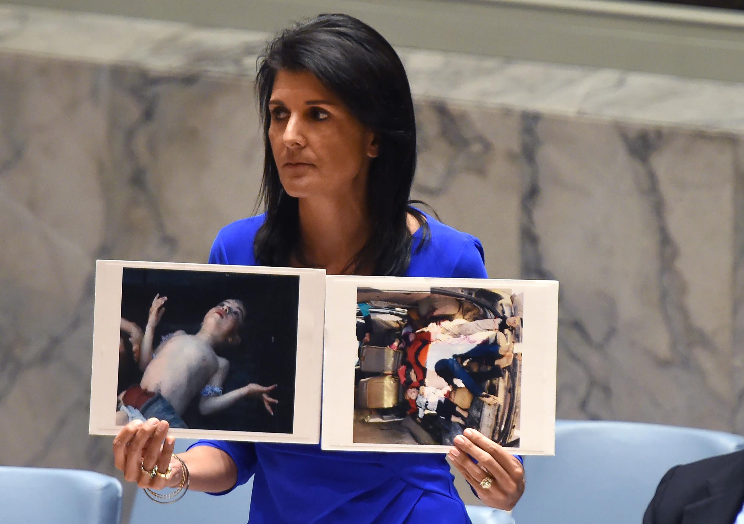 Nikki Haley, US ambassador to the UN, with photos of victims as she speaks during an emergency session at the UN on Wednesday