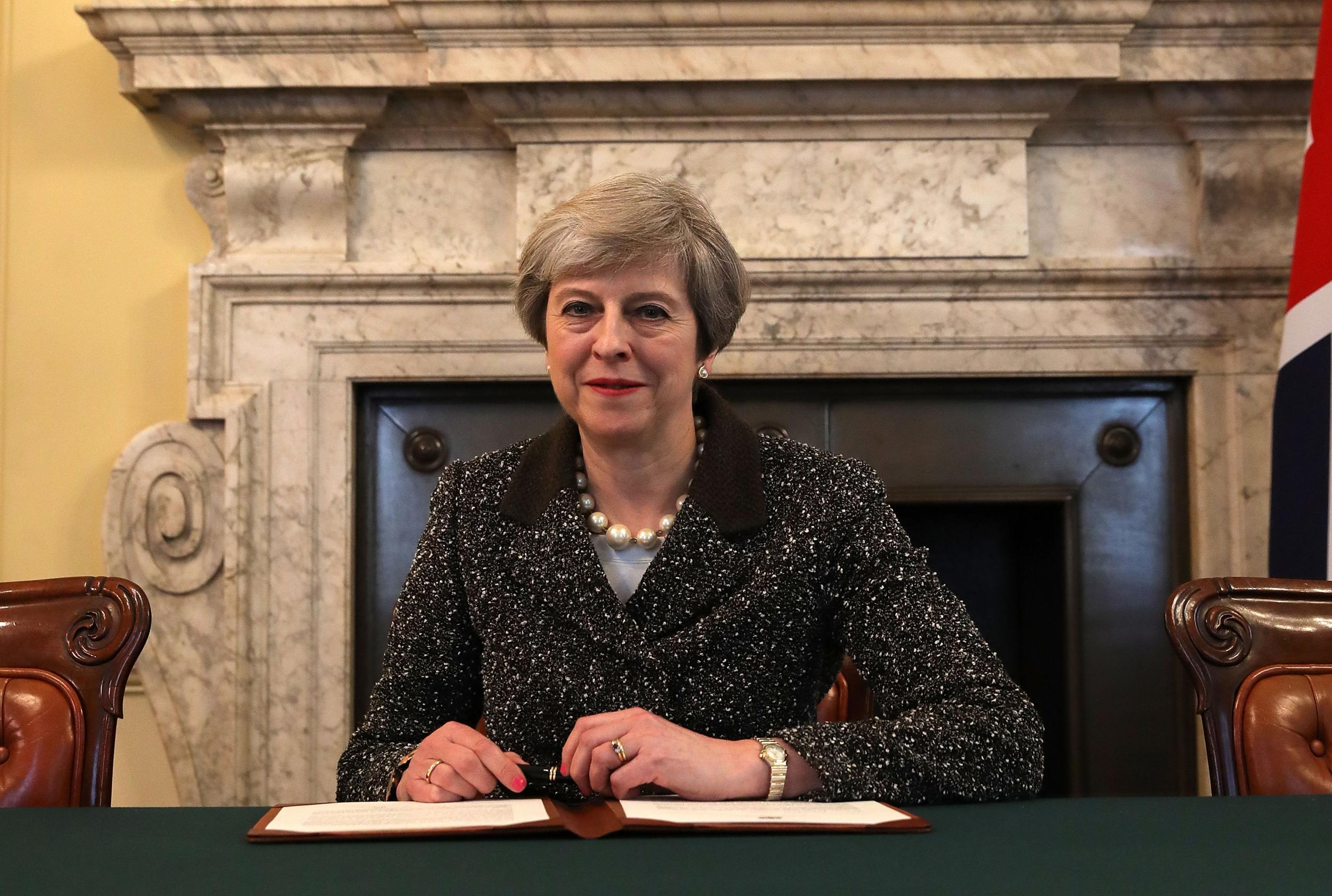 Theresa May signs the official letter to European Council President Donald Tusk, invoking Article 50