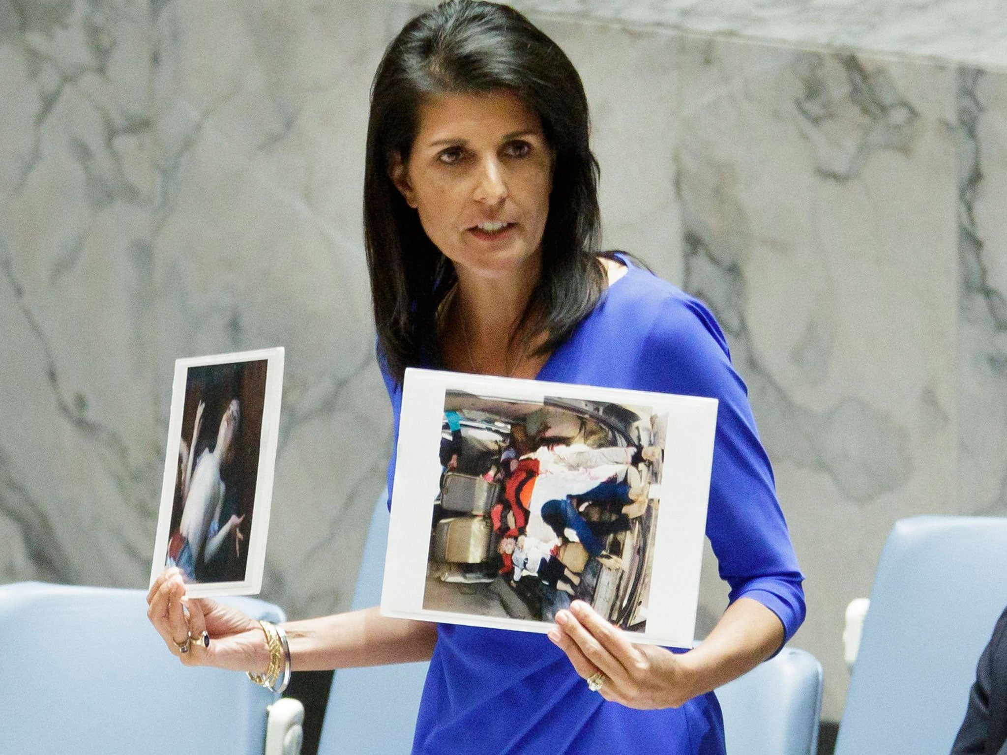 Nikki Haley, the United States' Ambassador to the United Nations, holds up images of victims of a chemical attack in Syria