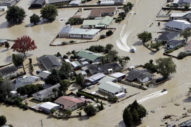 Jet boats drive through the flooded streets of the North Island town of Edgecumbe in New Zealand