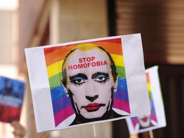 A protester holds up a sign showing Russian President Vladimir Putin wearing lipstick during a protest against Russian anti-gay laws in 2013. A similar image has been declared 'Internet extremism'
