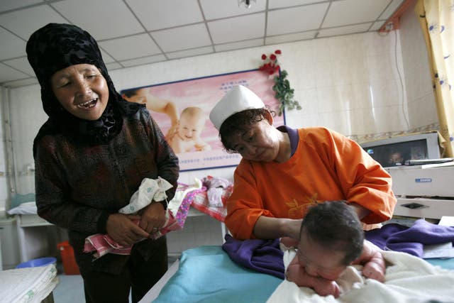 A mother-in-law looks at her grandson in Xining, Qinghai Province, China