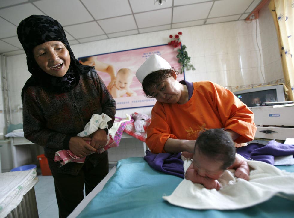 A mother-in-law looks at her grandson in Xining, Qinghai Province, China