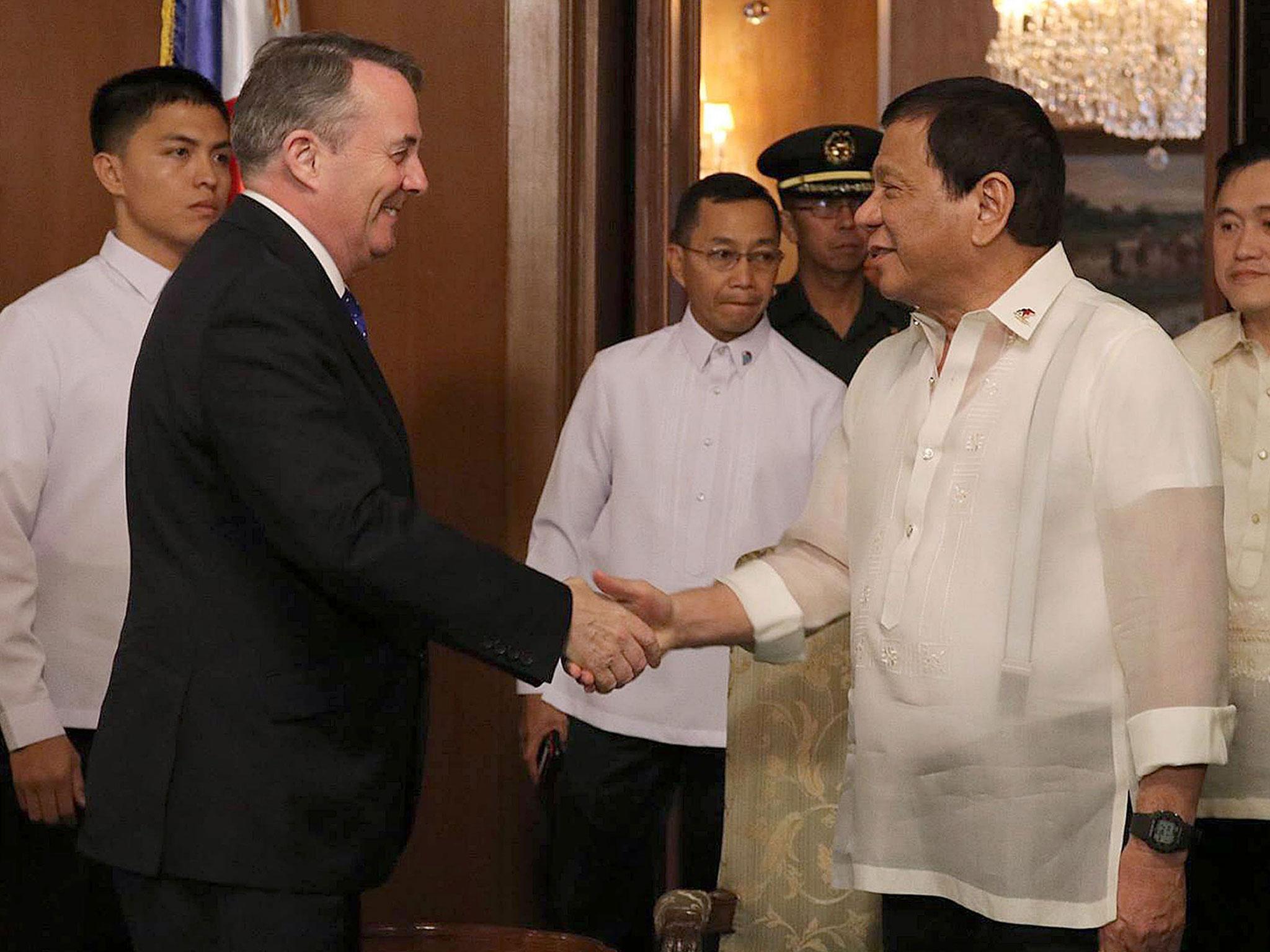 International Trade Secretary Liam Fox shakes hands with President of the Philippines Rodrigo Duterte