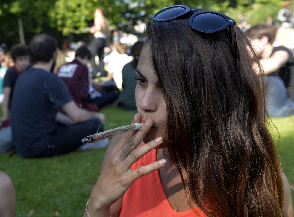 A woman smokes a joint during a 2014 demonstration in Paris calling for the legalisation of cannabis