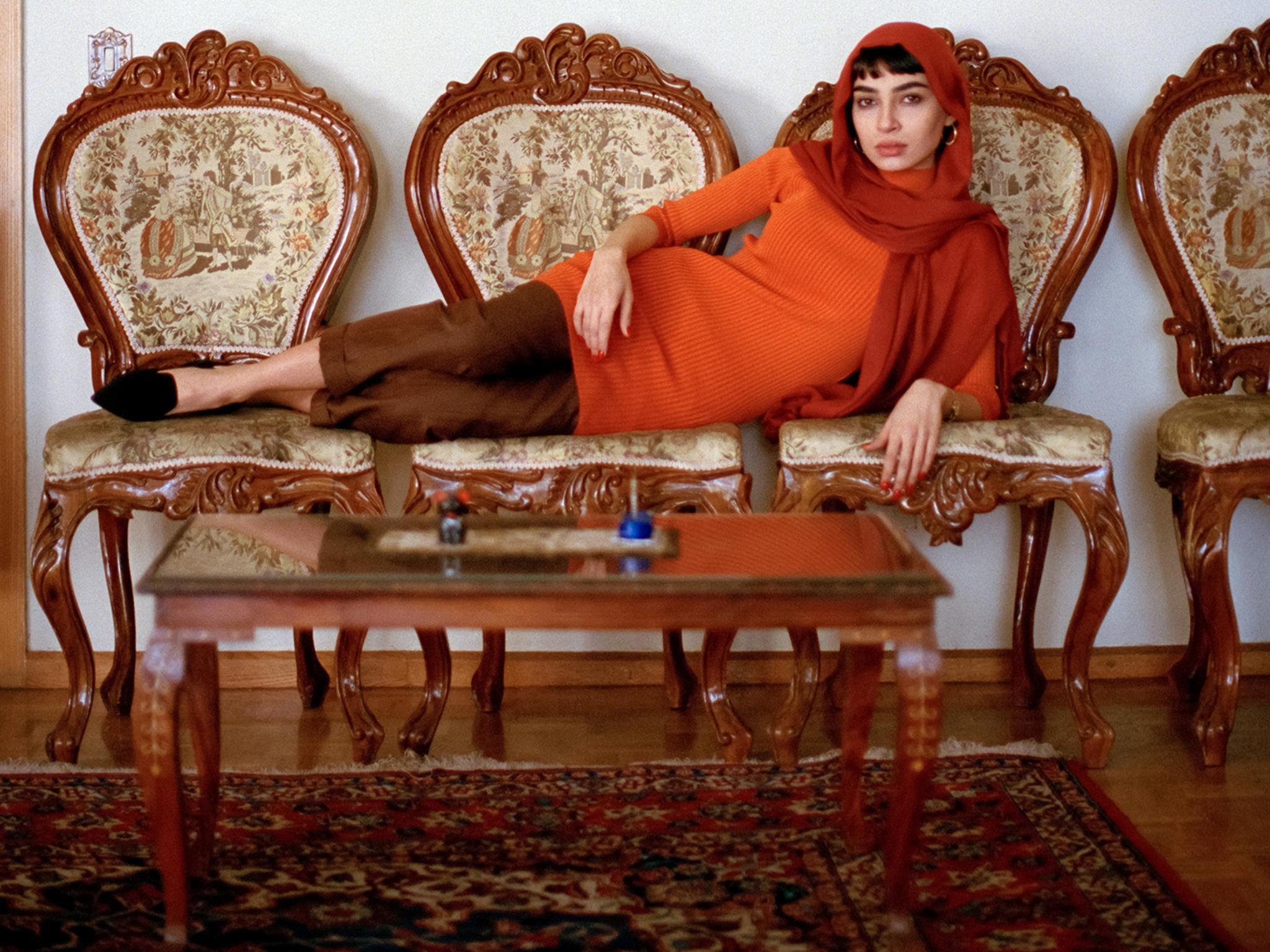A woman poses in her home for Olzac Bozalp