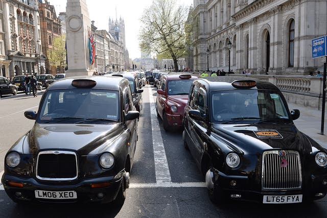 London black cab drivers hold a demonstration in Whitehall during a protest over the regulation private hire cars using the Uber app