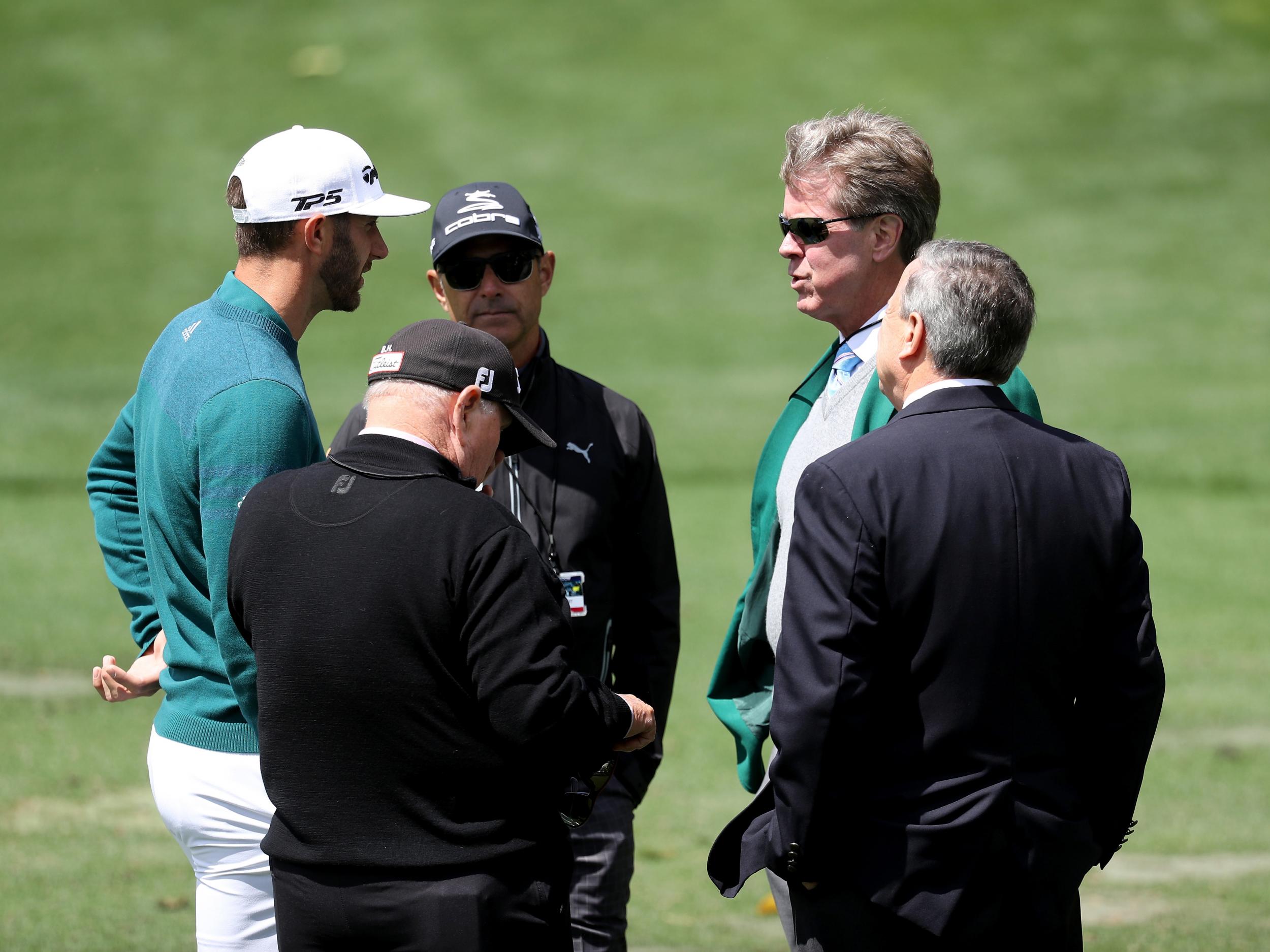 Johnson talks to Augusta National member Fred Ridley (2nd R)