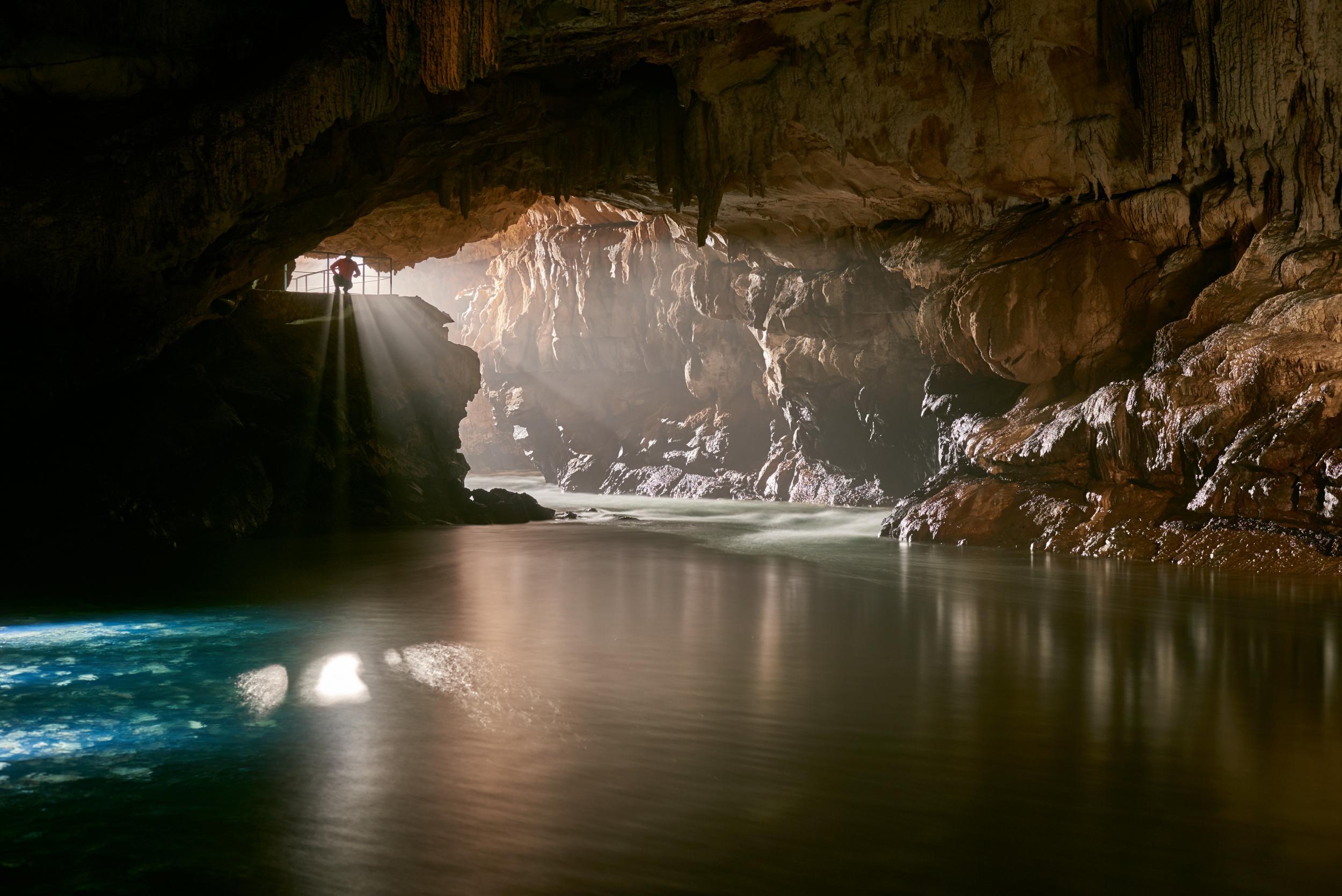 The underground river of Postojna Cave - visitors can abseil into its depths