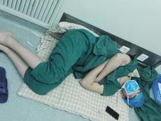 Chinese surgeon pictured sleeping after 28-hour shift called hero