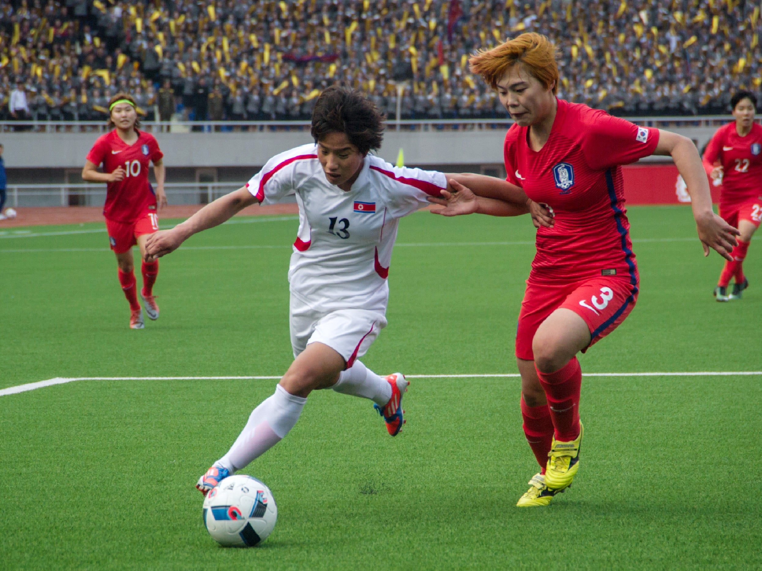 Ri Kyong-Hyang of North Korea fights for the ball with Shin Damyeong (AFP/Getty )