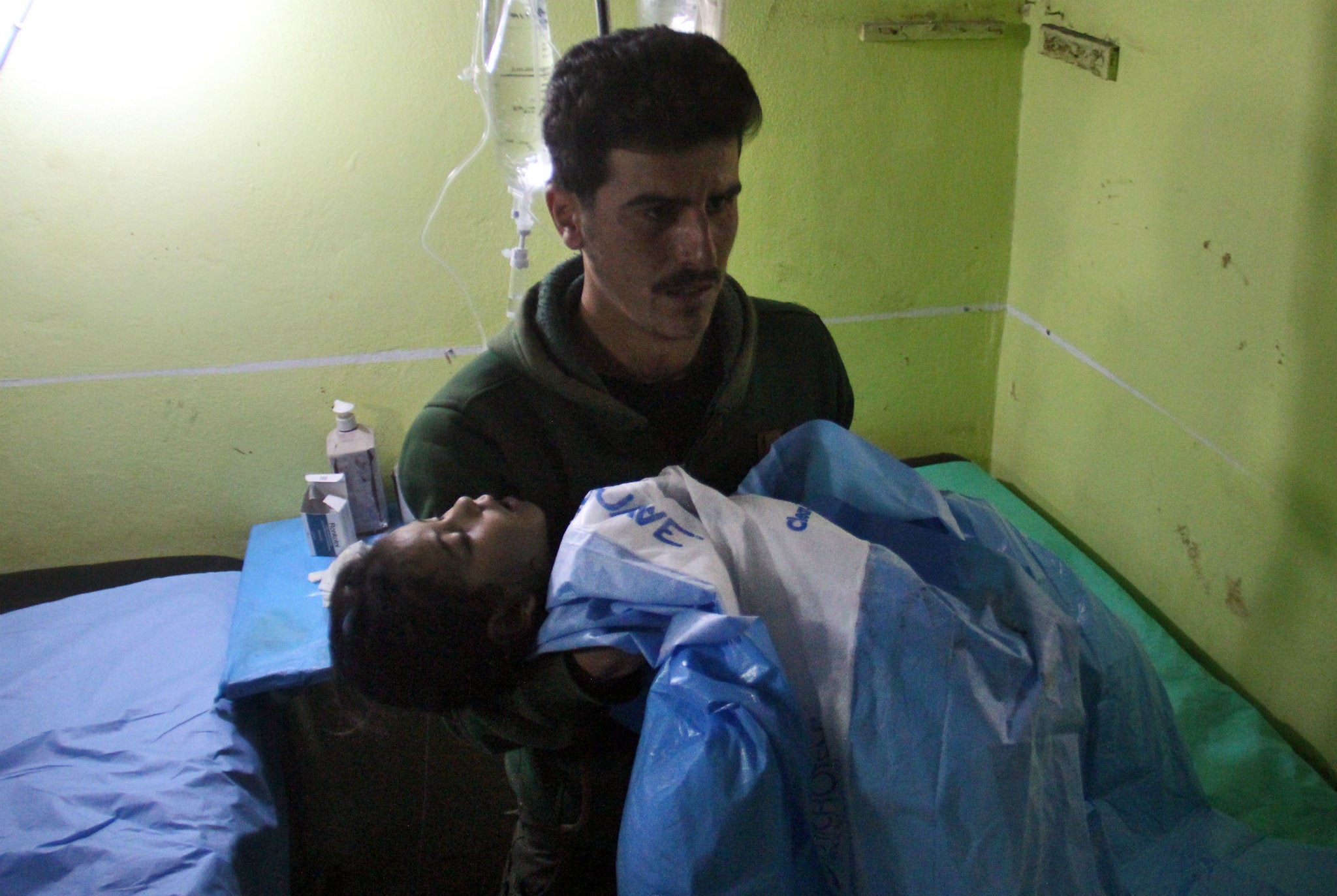 An unconscious Syrian child waits for treatment at a hospital in Khan Sheikhun, a rebel-held town in the northwestern Idlib province, following a suspected gas attack on 4 April