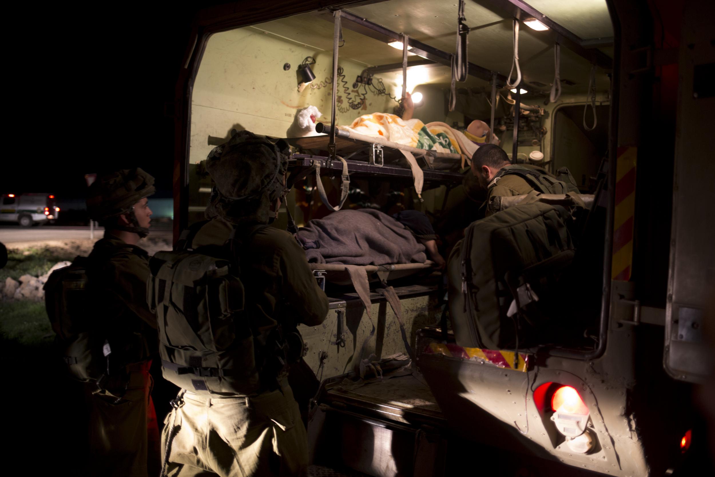Israeli military medics assist wounded Syrians in Israeli controlled Golan Heights