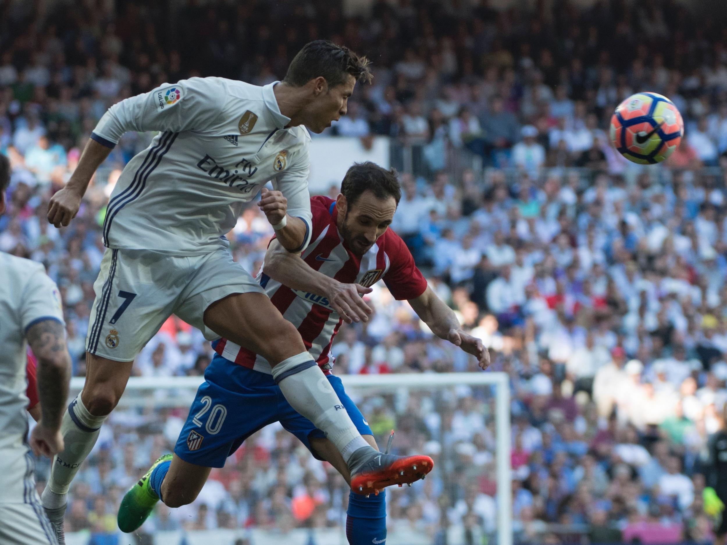 Ronaldo and Juanfran battle for the ball during the Madrid derby
