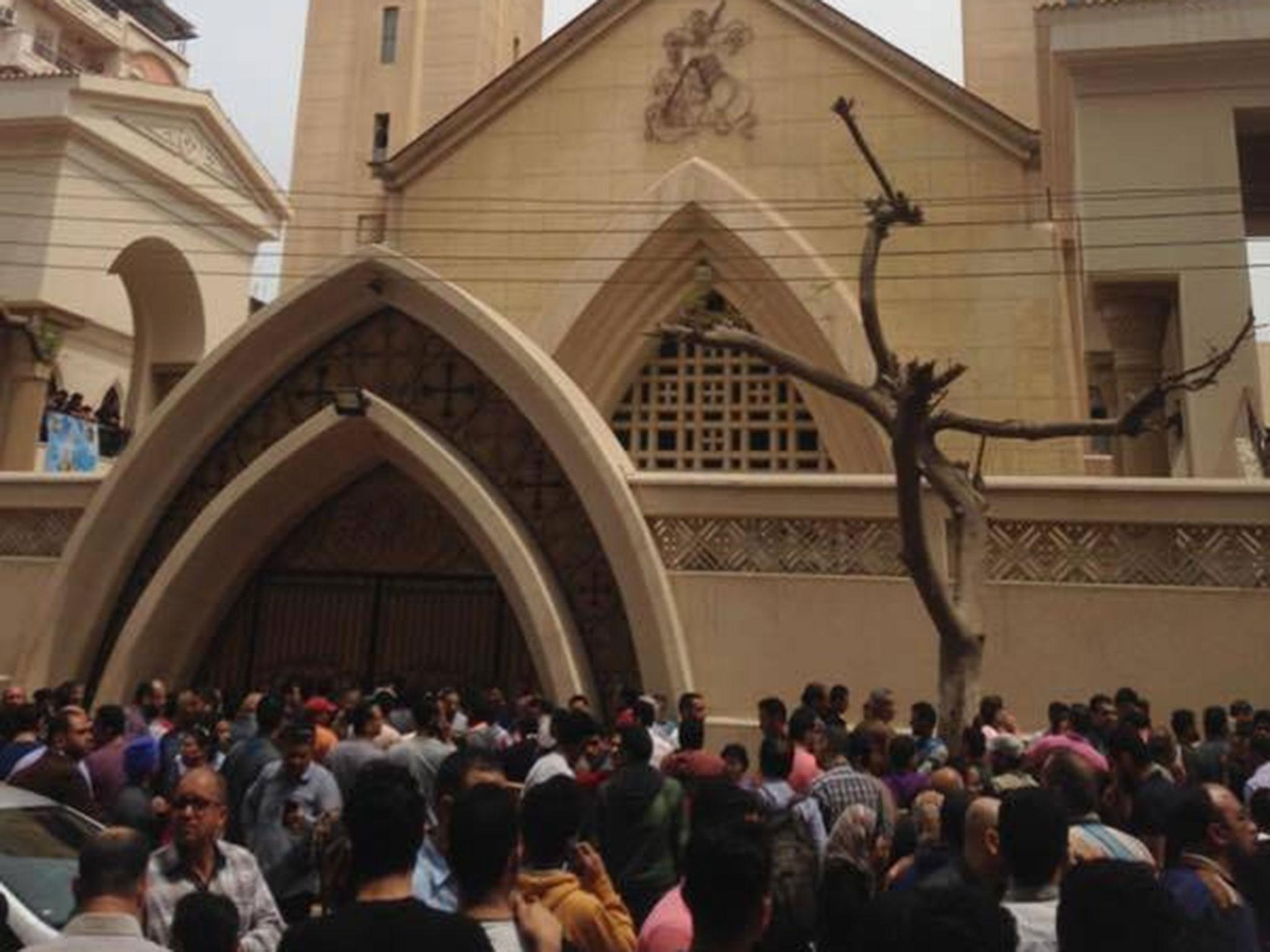 Relatives and onlookers gather outside the church Mar Girgis the bomb attack