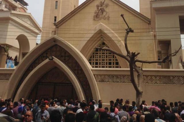 Relatives and onlookers gather outside the church Mar Girgis after a bomb attack on Palm Sunday, the start of the Holy Week leading up to Easter, when the church in the Nile Delta town of Tanta was packed with worshippers