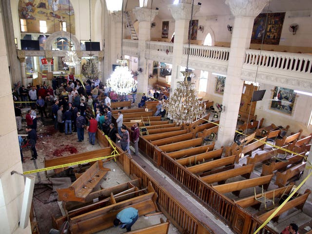 Security personnel investigate the scene of a bomb explosion inside Mar Girgis church in Tanta