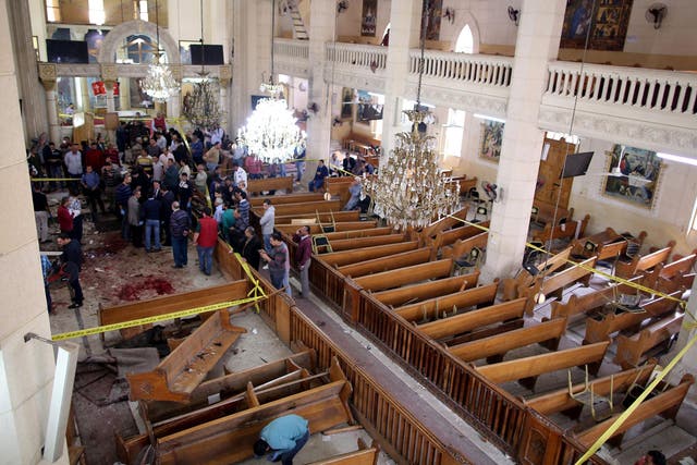 Security personnel investigate the scene of a bomb explosion inside Mar Girgis church in Tanta