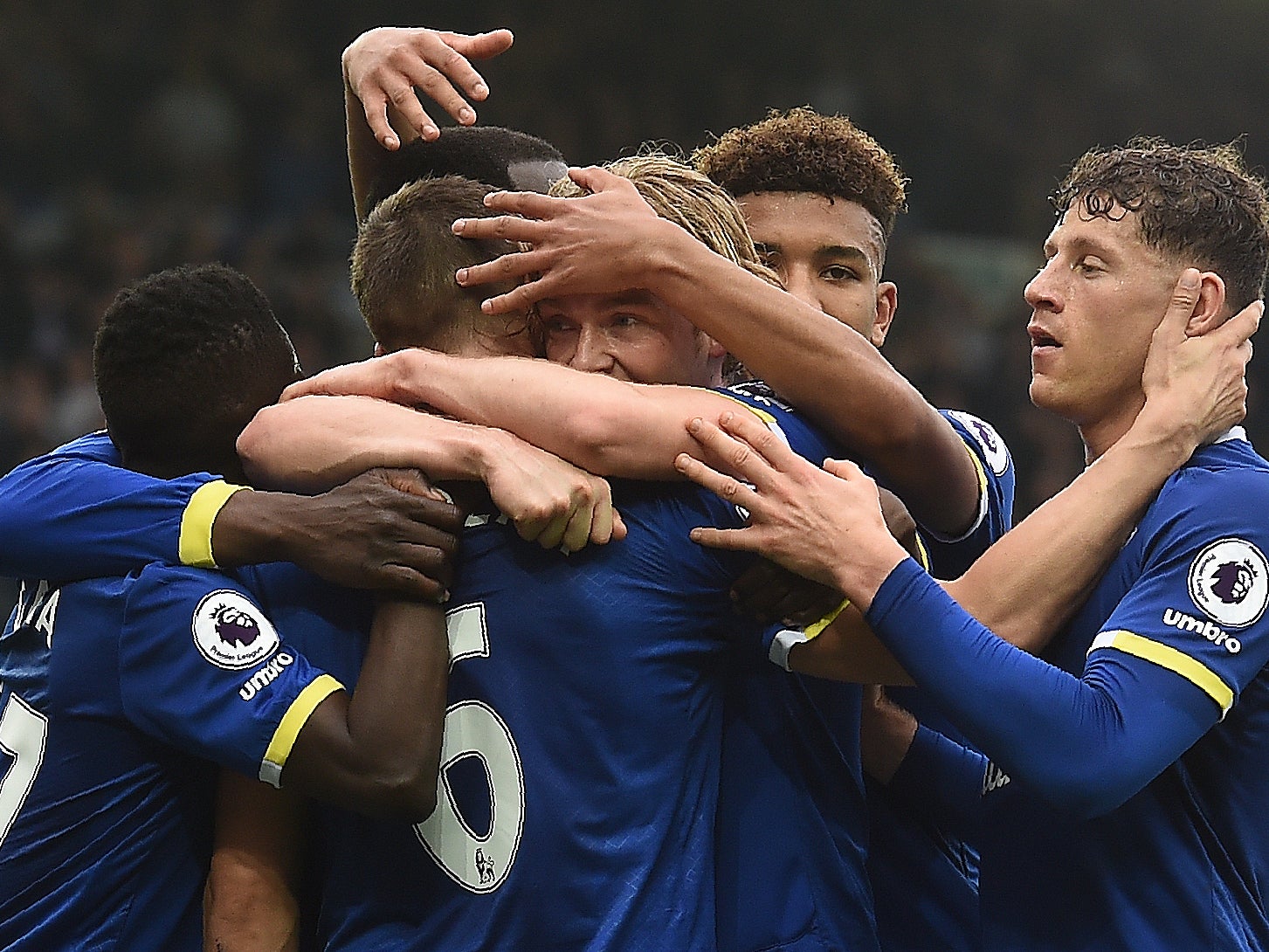 Davies is mobbed by his team-mates after giving Everton the lead within thirty seconds