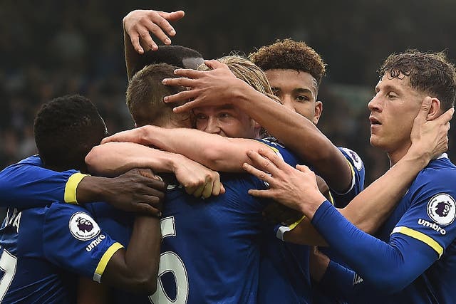 Davies is mobbed by his team-mates after giving Everton the lead within thirty seconds