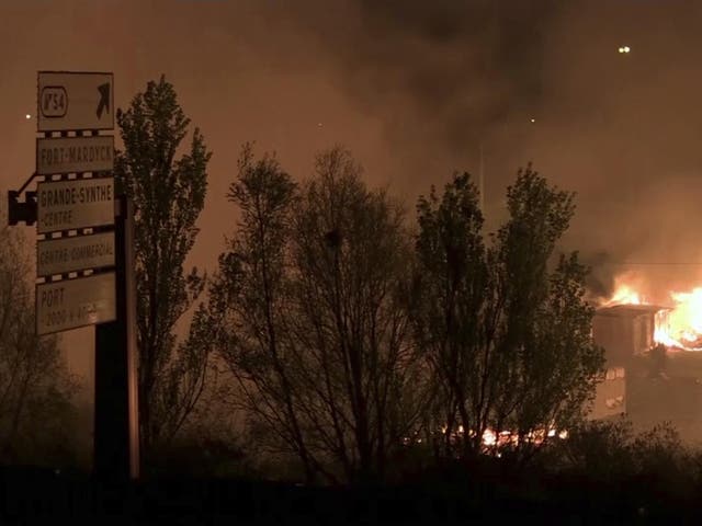 A huge blaze ravaged the camp in northern France, destroying  shelters and forcing the evacuation of hundreds of migrants
