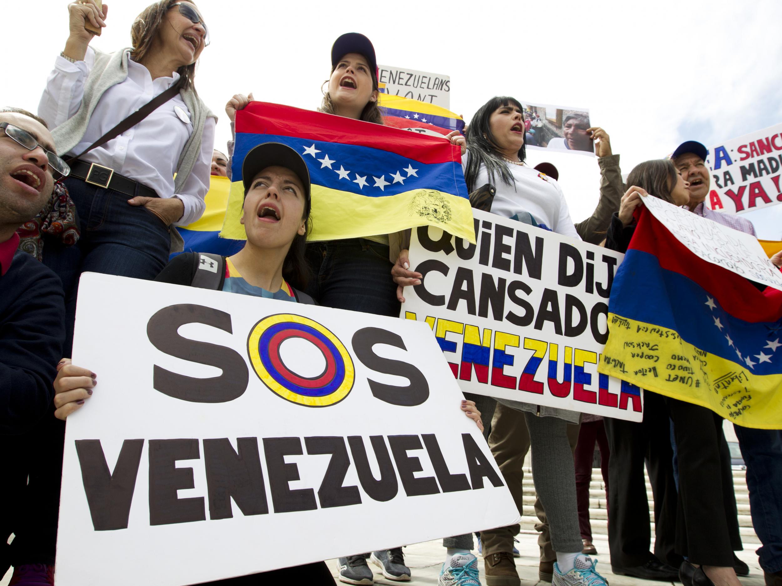 Demonstrators against the Venezuelan government chant outside of the Organization of American States