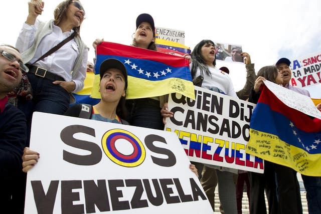Demonstrators against the Venezuelan government chant outside of the Organization of American States