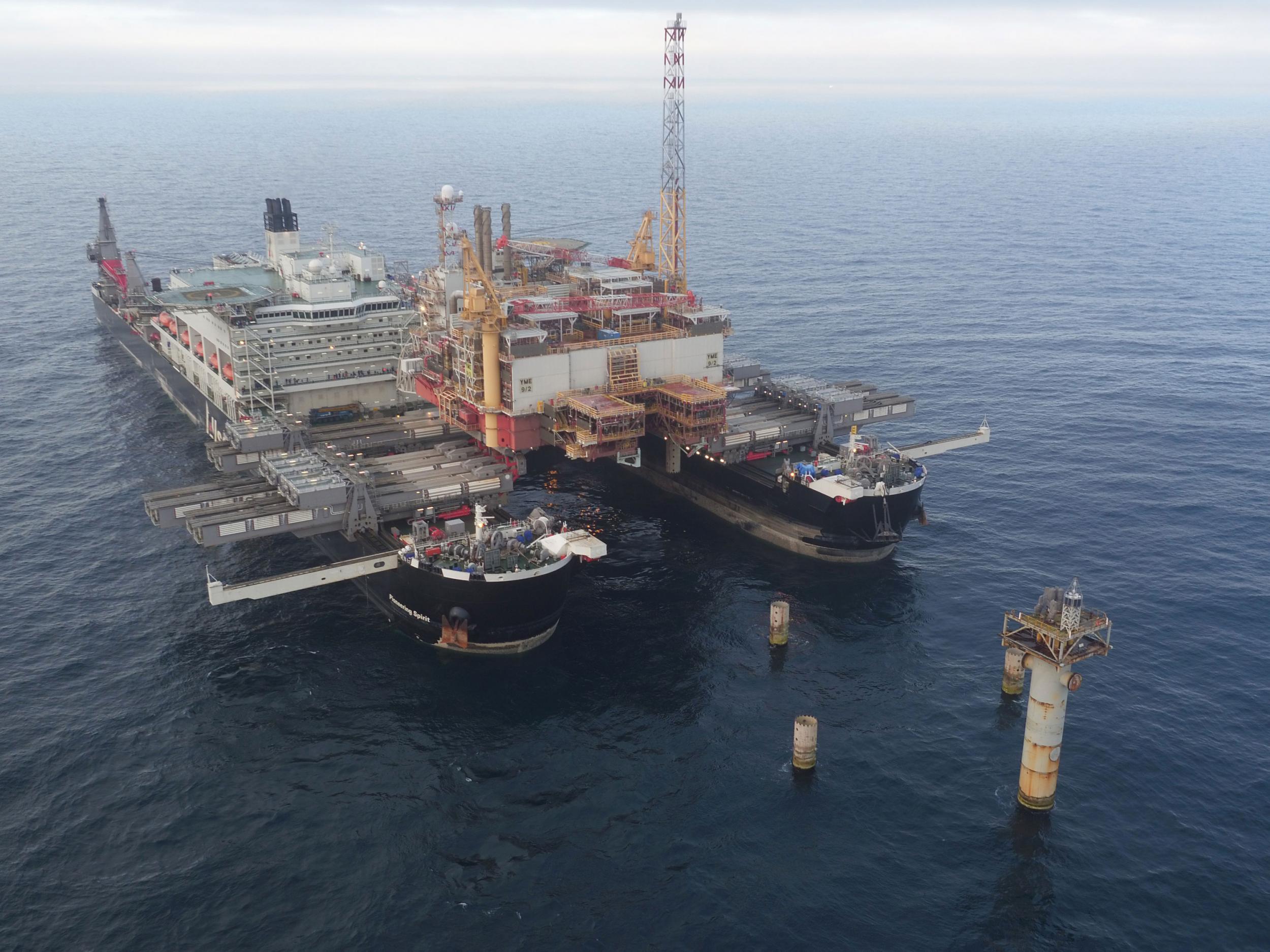 The Pioneering Spirit, the largest ship ever built, shortly after it removed the Norweigan Yme oil rig's topside from its concrete legs. It will soon carry out a similar operation on the much larger, British-owned platform.