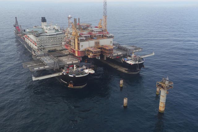 The Pioneering Spirit, the largest ship ever built, shortly after it removed the Norweigan Yme oil rig's topside from its concrete legs. It will soon carry out a similar operation on the much larger, British-owned platform.