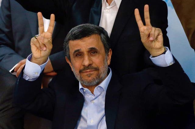 Mahmoud Ahmadinejad flashes the sign for victory at the Interior Ministry’s election headquarters as candidates sign up for the upcoming presidential elections in Tehran on 12 April 2017