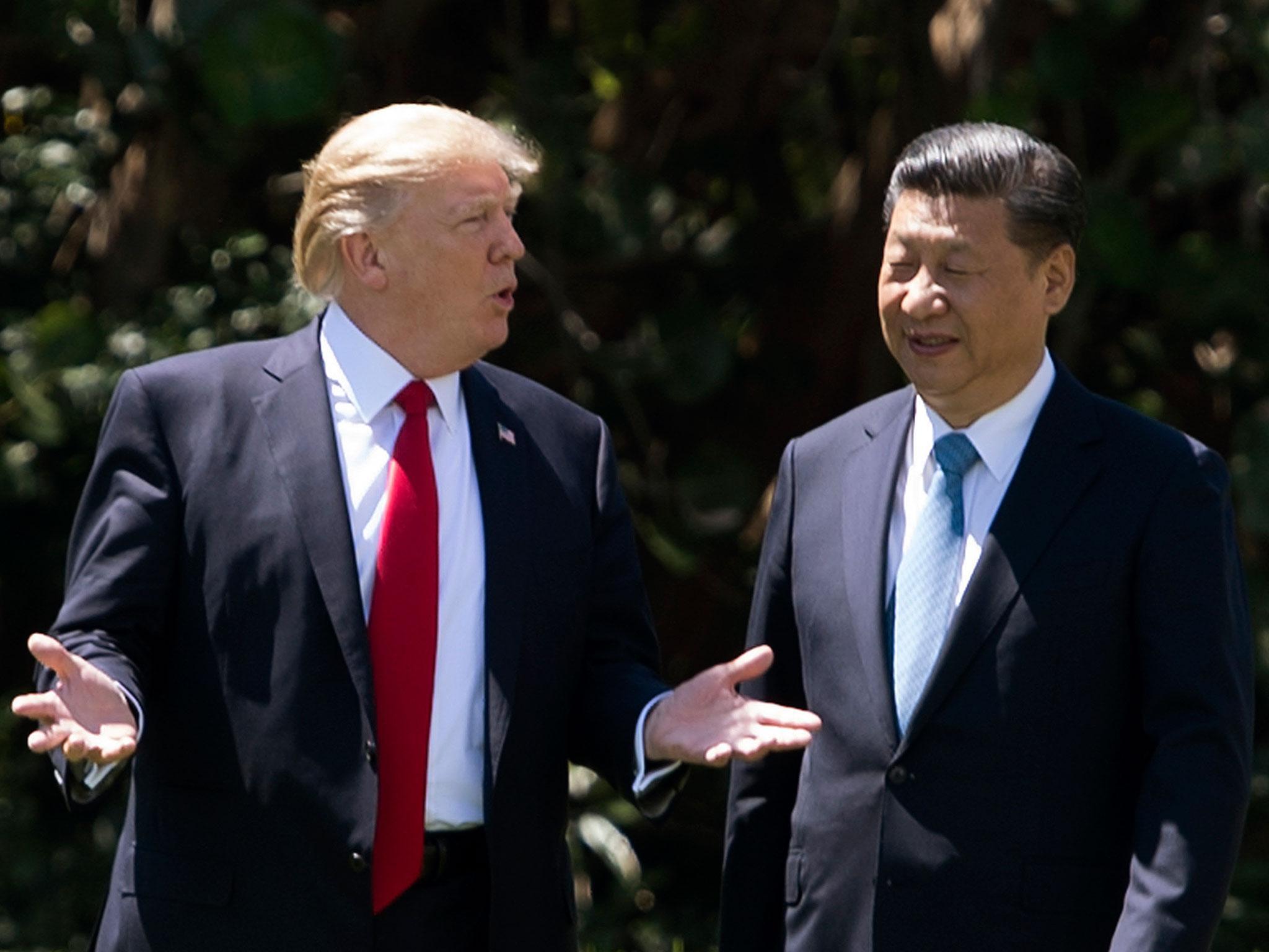 Donald Trump and Chinese Premier Xi Jinping at the former's Florida resort Mar-a-Lago earlier this year