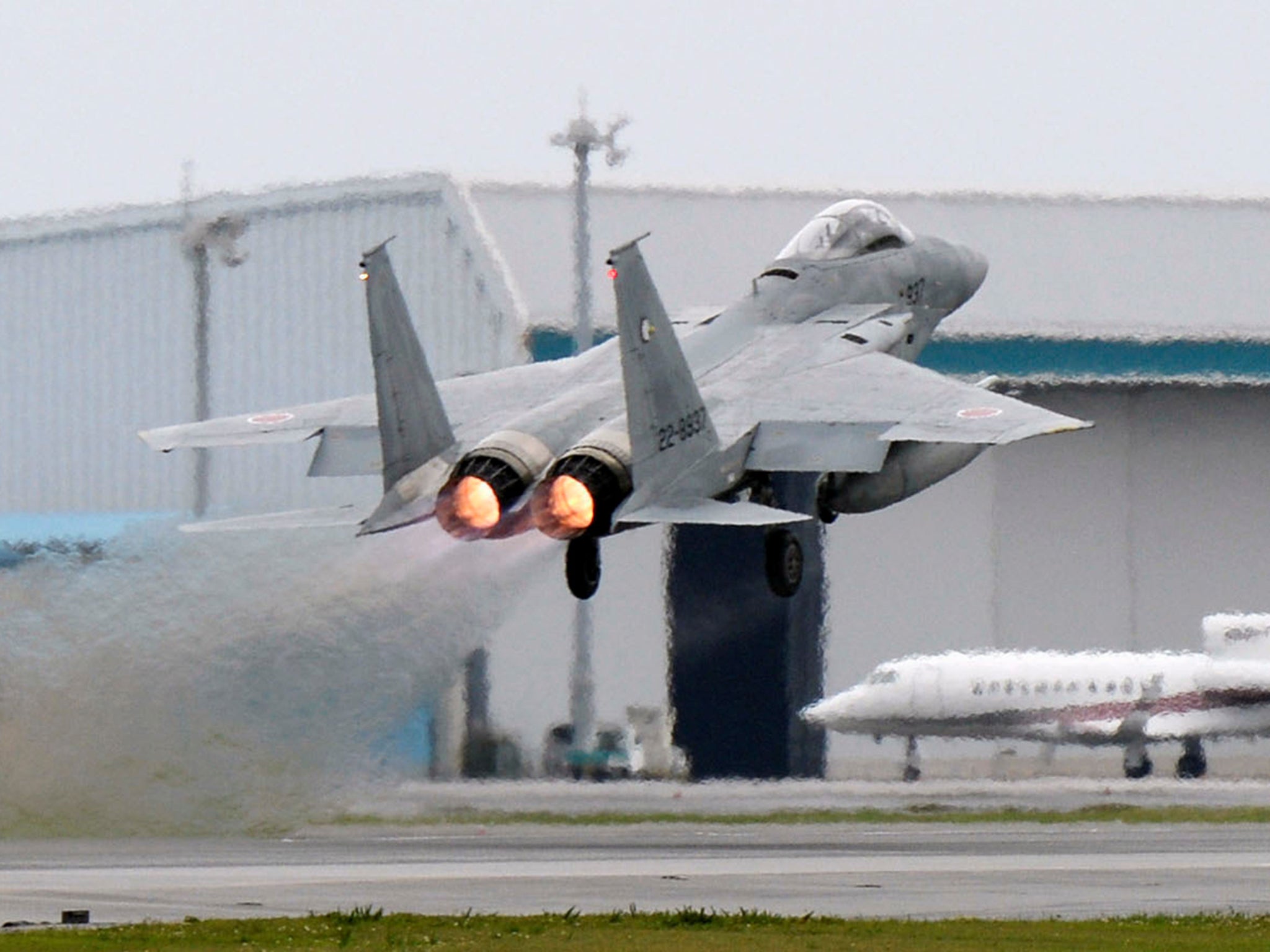 A Japanese Air Self Defence Force F-15 fighter scrambles at the Air Self Defense Force Naha base in Naha, Okinawa